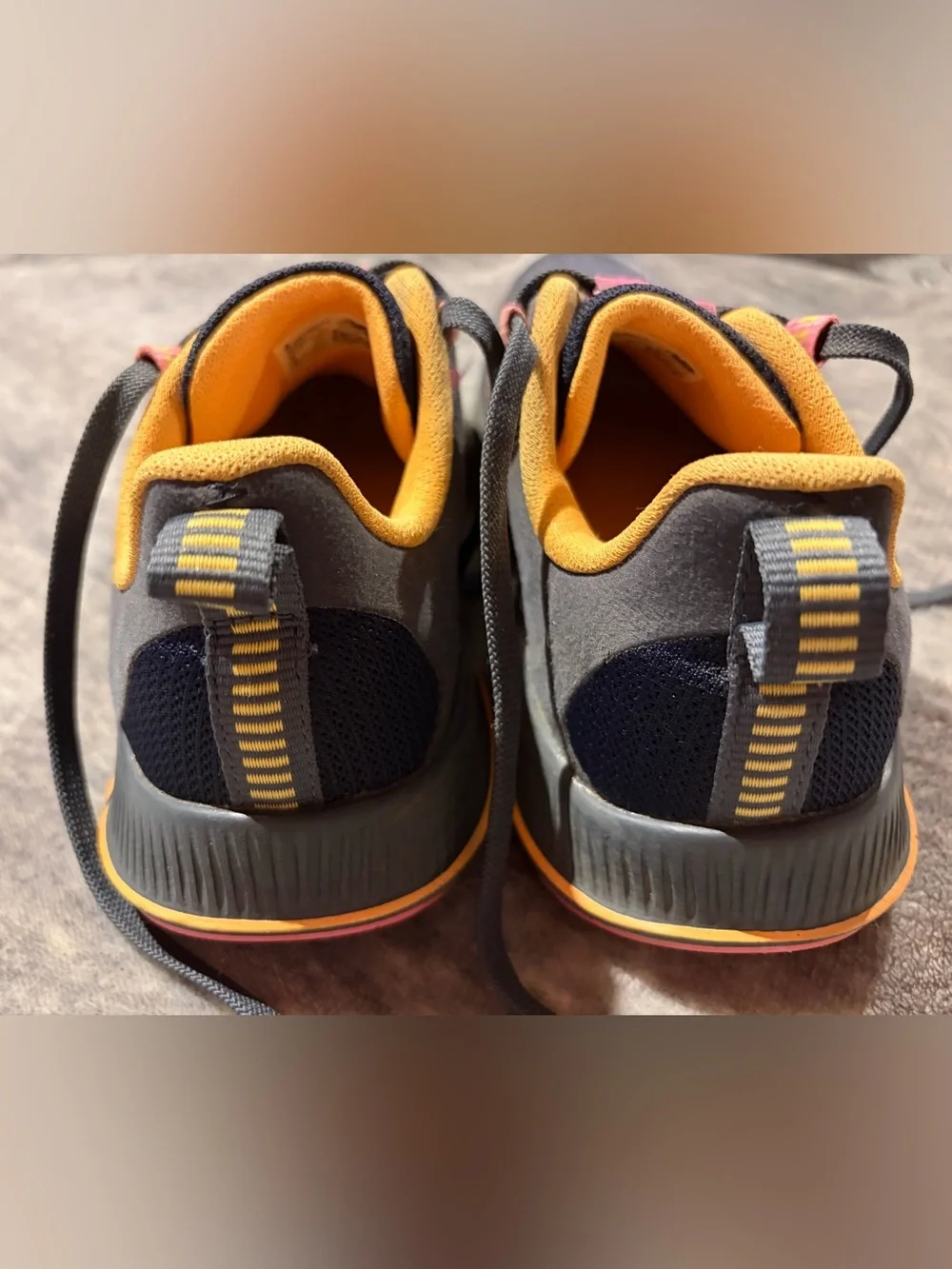 New Balance navy athletic sneakers with yellow and pink accents